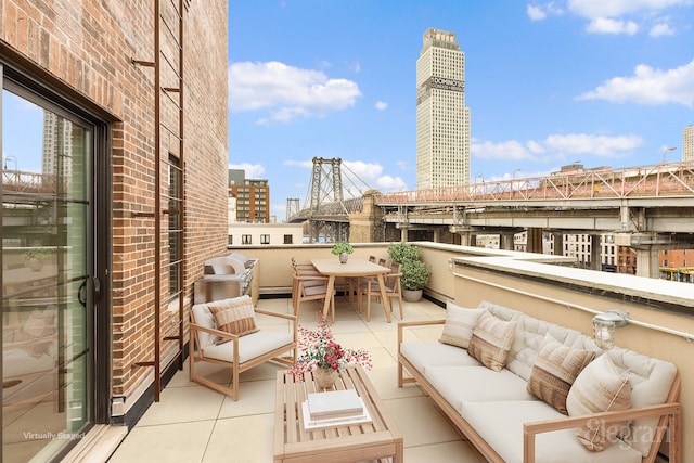 balcony with a city view and an outdoor hangout area