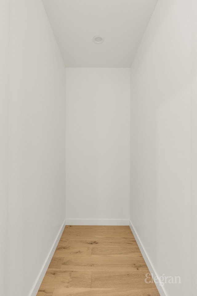 unfurnished room with light wood-style floors and baseboards