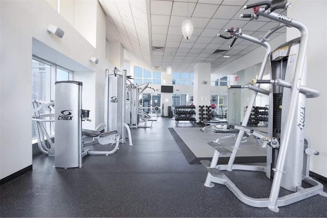 workout area with a high ceiling and a drop ceiling