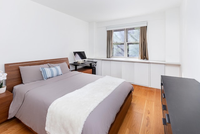 bedroom with light wood finished floors