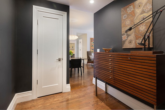 bedroom with light wood finished floors and baseboards