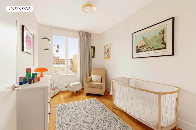 bedroom with visible vents, baseboards, and wood finished floors