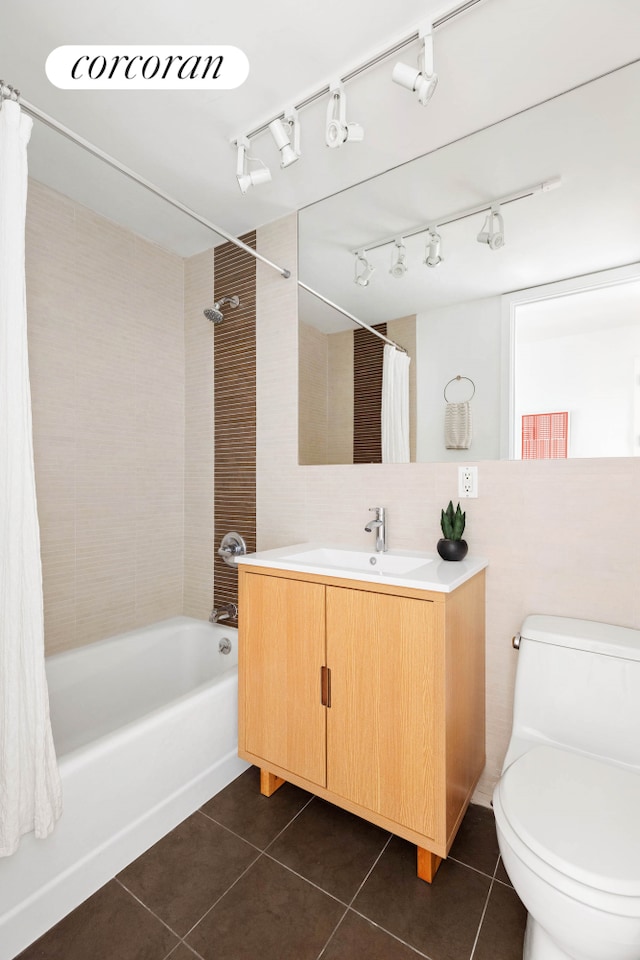 bathroom featuring toilet, shower / bath combo with shower curtain, decorative backsplash, tile patterned floors, and vanity