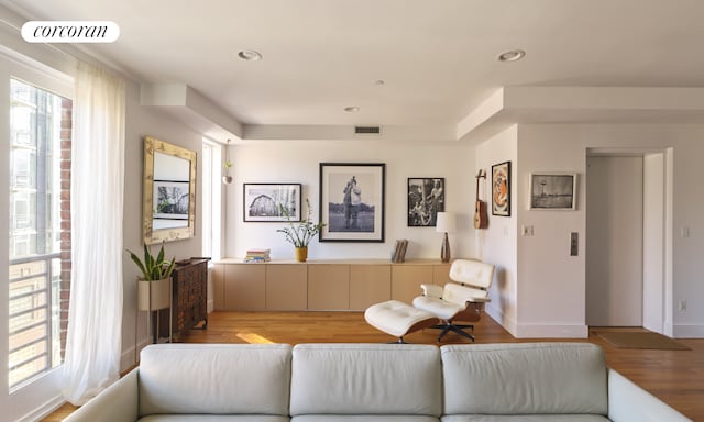 living area with recessed lighting, visible vents, and light wood-style flooring