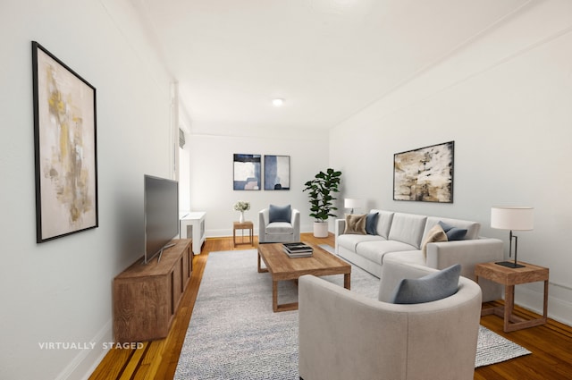 living area featuring baseboards and wood finished floors