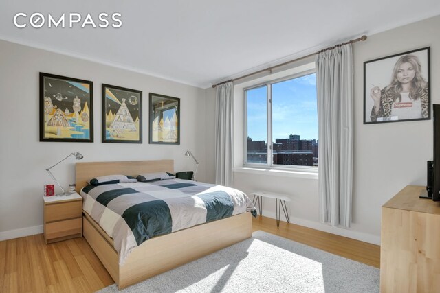 bedroom featuring baseboards and light wood-type flooring