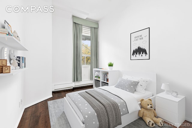 bedroom with wood finished floors and baseboards