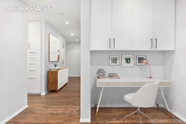 office space featuring baseboards, wood finished floors, recessed lighting, and built in study area
