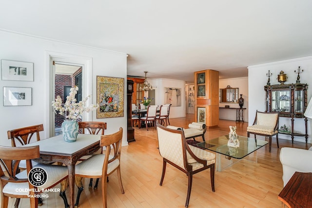 50 Sutton Pl S Unit 14G, New York City, NY 10022 - dining room featuring ornamental molding, light wood finished floors, and a chandelier