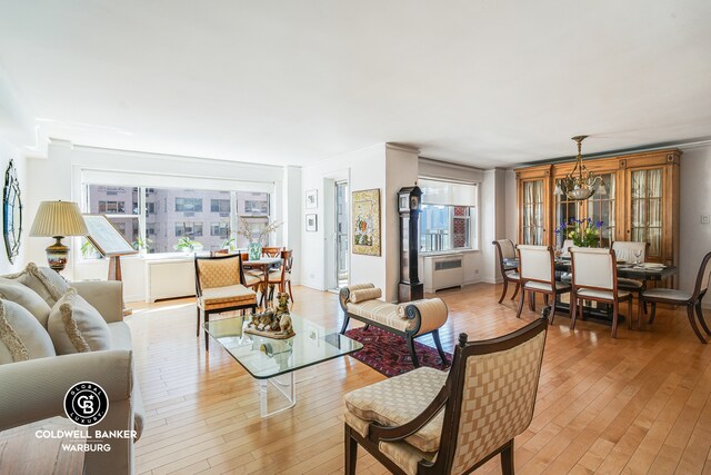 dining area featuring crown molding and light wood-type flooring