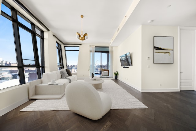 living area with an inviting chandelier and baseboards