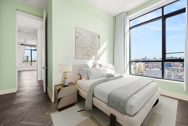 bedroom featuring baseboards and multiple windows