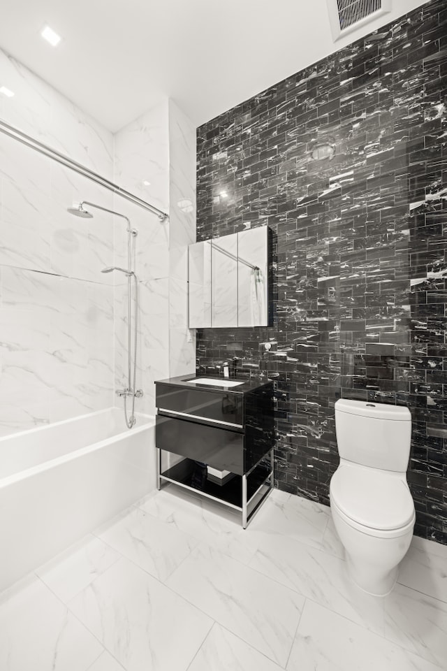 bathroom featuring visible vents, toilet, marble finish floor, shower / tub combination, and vanity