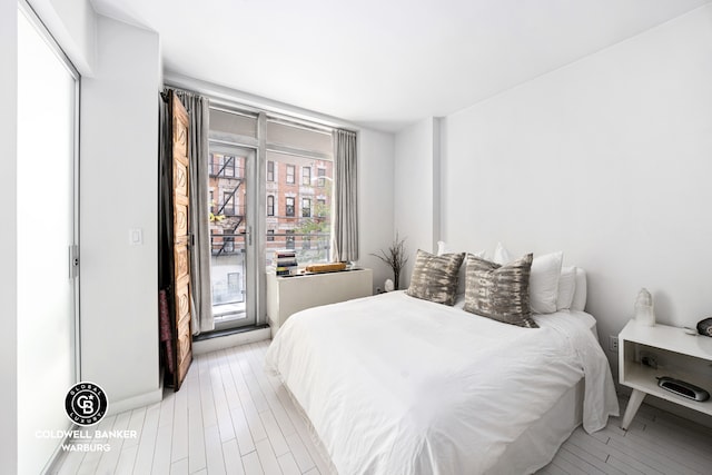 bedroom featuring access to outside and light wood finished floors