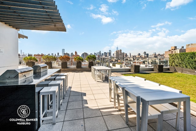 view of patio with a view of city and area for grilling