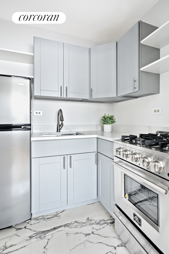 kitchen with a sink, stainless steel appliances, open shelves, and light countertops