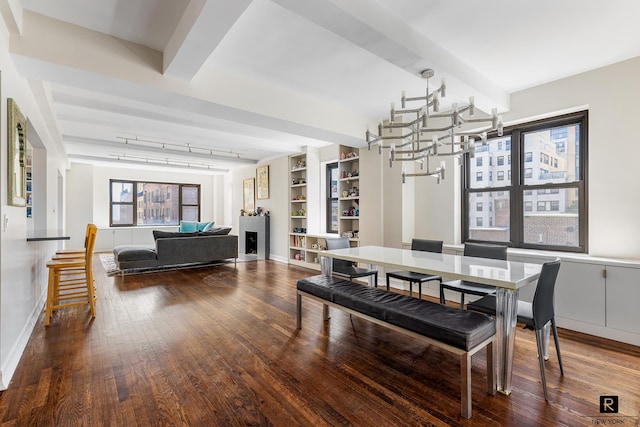 dining space with baseboards, a notable chandelier, beam ceiling, and hardwood / wood-style flooring