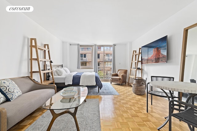 living area with baseboards and visible vents