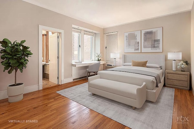 bedroom featuring baseboards and light wood-style floors