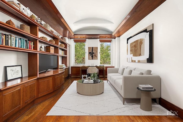 living area with baseboards, lofted ceiling, and dark wood-style flooring