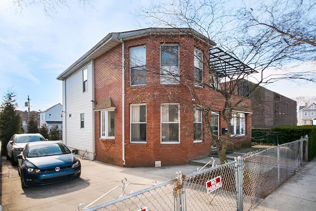 1176 E 94th St, New York City, NY 11236 - view of front of home with brick siding, a gate, crawl space, and a fenced front yard