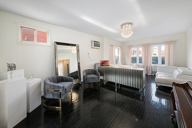 bedroom featuring dark wood-type flooring, an AC wall unit, and a chandelier