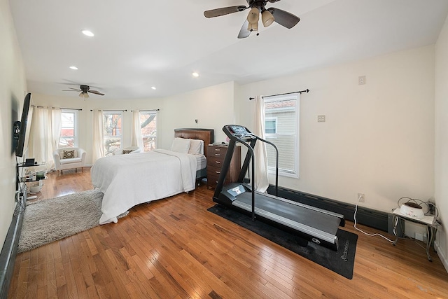 bedroom with recessed lighting, hardwood / wood-style floors, and a ceiling fan