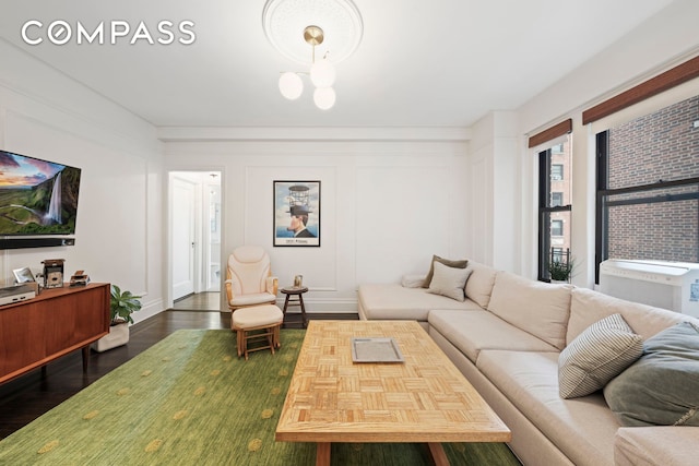 living area with a decorative wall and wood finished floors