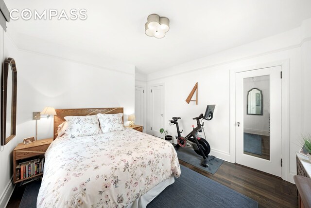 150 E 93rd St Unit 5B, New York City, NY 10128 - bedroom with dark wood-style floors and baseboards