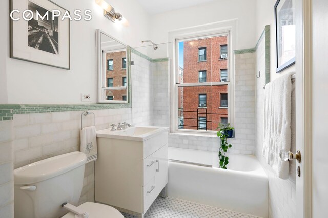 150 E 93rd St Unit 5B, New York City, NY 10128 - full bath with tile walls, vanity, and shower / washtub combination