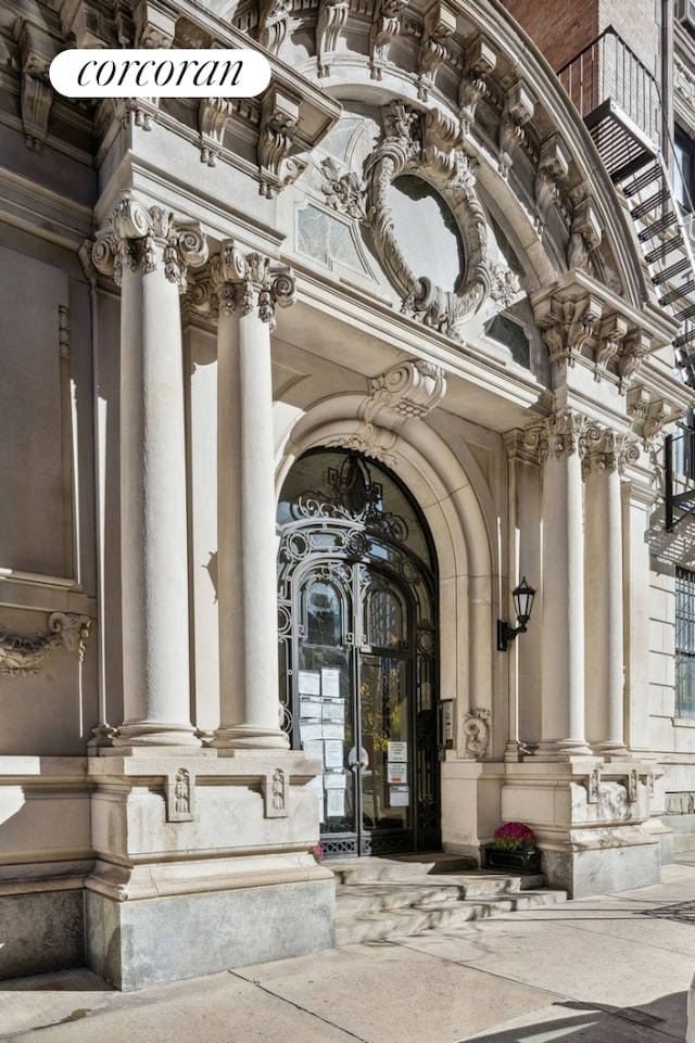 view of home's community with decorative columns