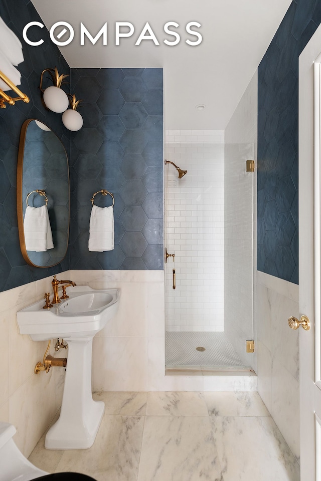 full bathroom with tile walls and a shower stall