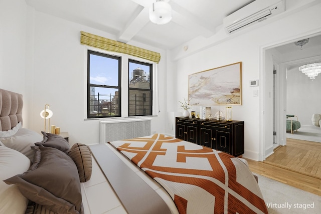 bedroom featuring light wood-style floors, beam ceiling, an AC wall unit, a notable chandelier, and radiator heating unit