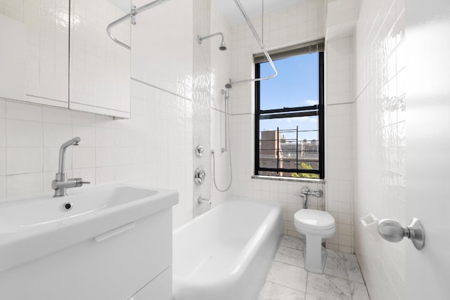 full bath featuring tile walls, toilet, bathing tub / shower combination, marble finish floor, and vanity