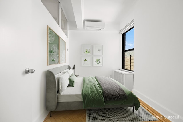 bedroom with an AC wall unit, radiator, and baseboards