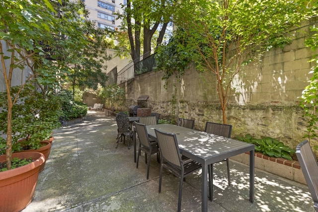 view of patio / terrace with outdoor dining area and fence