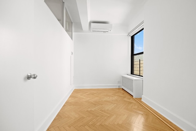 unfurnished room featuring baseboards, a wall mounted AC, and radiator heating unit