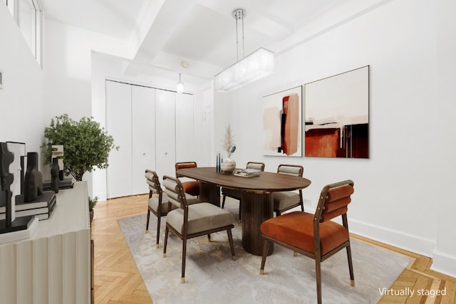 dining area featuring beam ceiling and baseboards