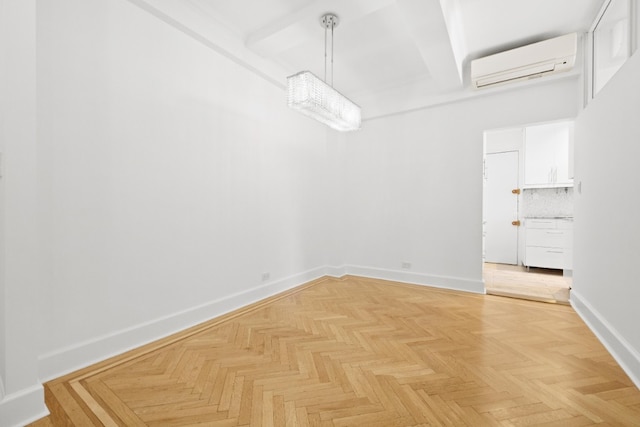unfurnished dining area featuring baseboards and a wall mounted air conditioner