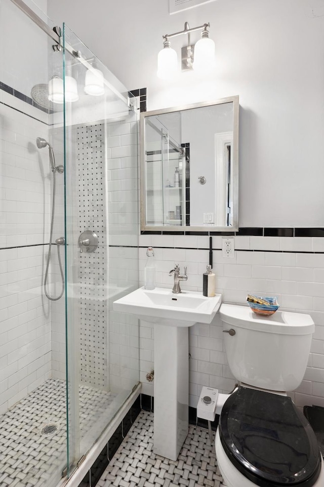 353 Riverside Dr Unit 4B, New York City, NY 10025 - bathroom featuring toilet, tile walls, a stall shower, and tile patterned flooring