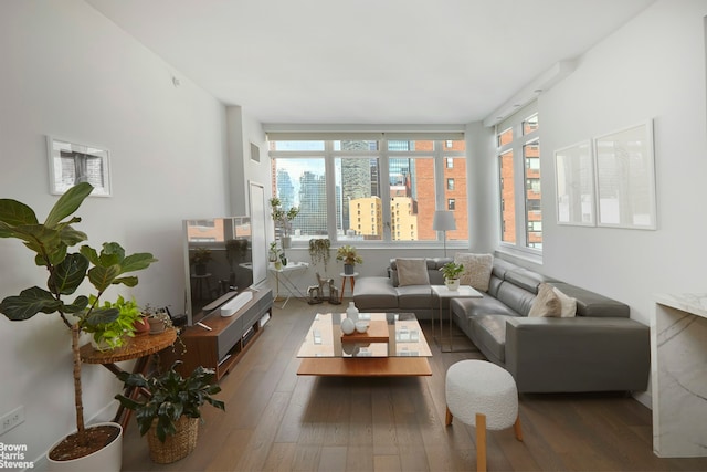 living area featuring visible vents and hardwood / wood-style flooring