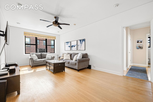 living room with baseboards, light wood-style flooring, and a ceiling fan