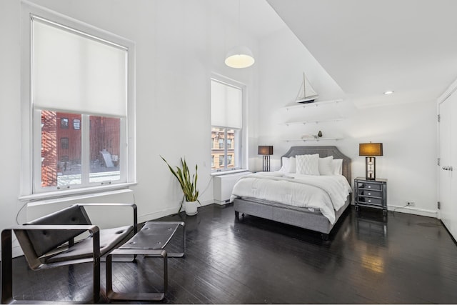 bedroom featuring recessed lighting, baseboards, and dark wood-style flooring