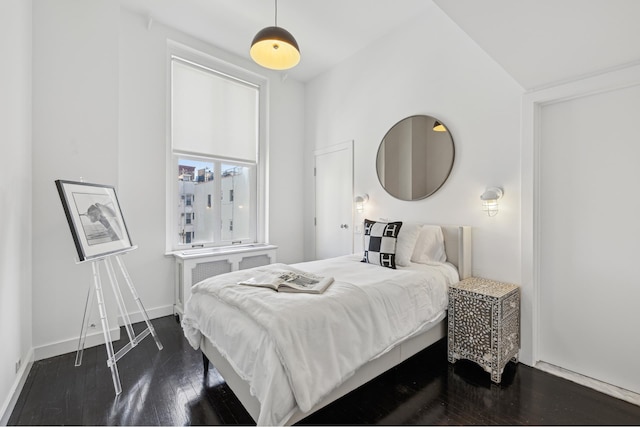 bedroom with dark wood-style floors and baseboards