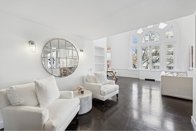 sitting room with dark wood-type flooring