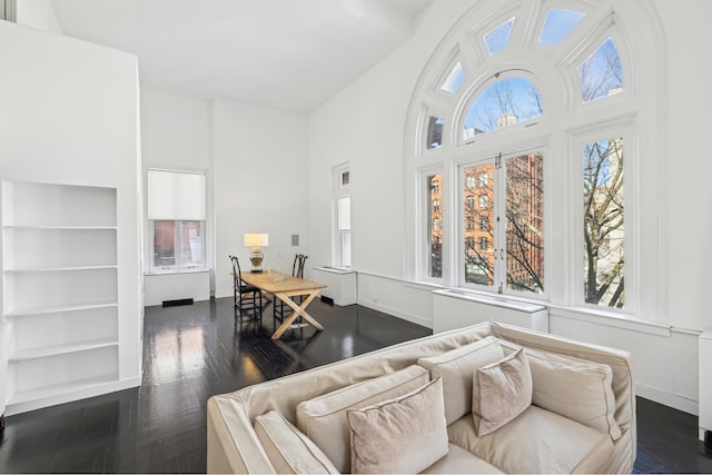 interior space featuring baseboards and dark wood-type flooring