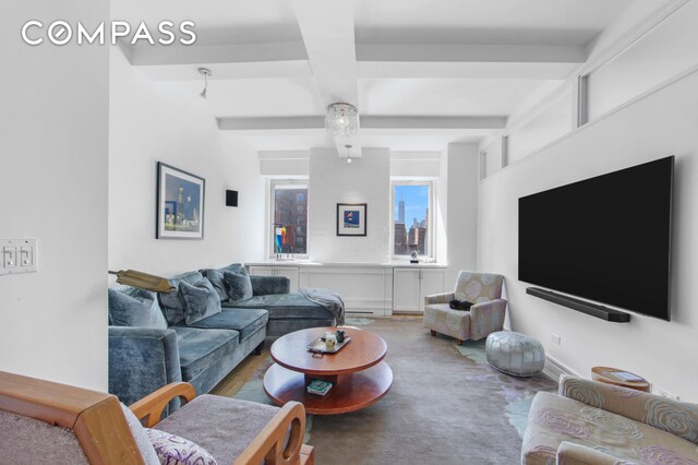 living area with beam ceiling