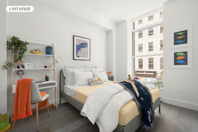 bedroom with wood finished floors, baseboards, and multiple windows