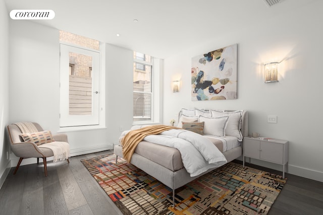 bedroom featuring wood finished floors and baseboards