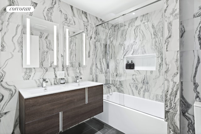 bathroom featuring bathing tub / shower combination, double vanity, and tile walls